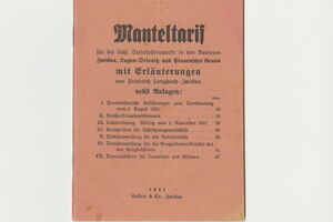 Zu sehen ist ein Bild eines Manteltarifs. Der Umschlag hat eine orange Farbe und ist mit altdeutscher Schrift versehen.